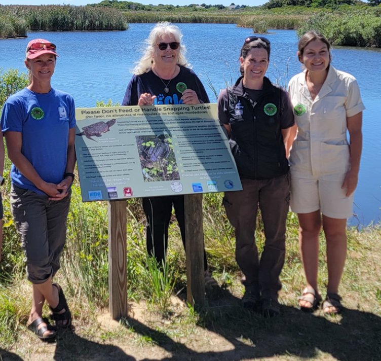 From left, Team Turtle members Danielle O&rsquo;Dell, Susan Richards, Sarah Bois and Eve Wetlaufer with the new sign at Long Pond urging people not to feed the snapping turtles.