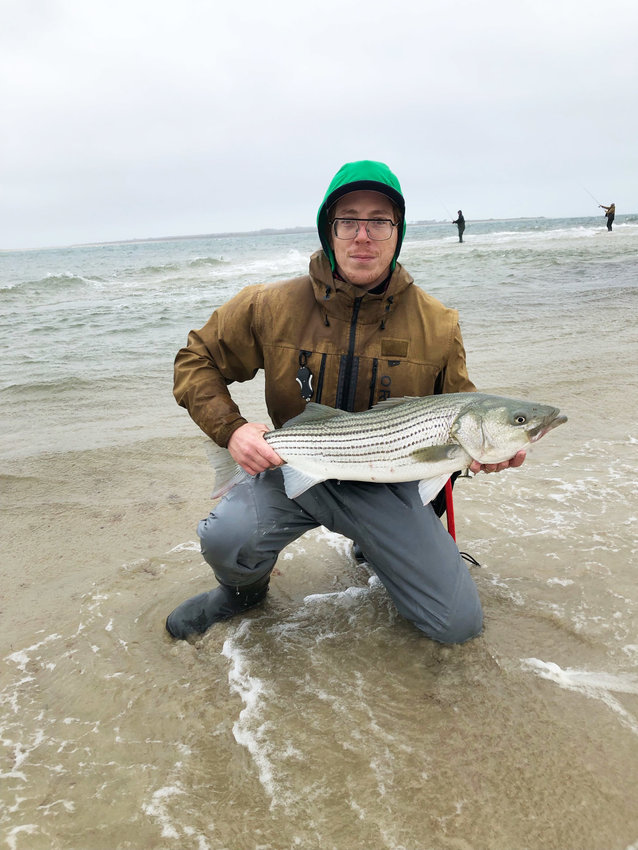 Hamid Baboush with a striped bass he caught on the south shore this week.