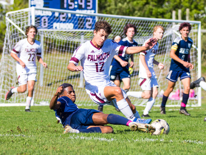 Rodane Watson clears the ball off the foot of a Falmouth player with a slide tackle during the Whalers' 2-0 loss at home Friday.