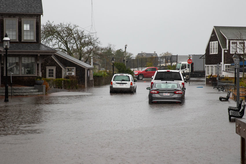 Cars wade their way down a flooded Easy Street.