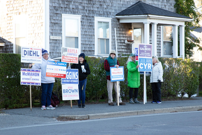 Supporters campaign for their candidates across from Nantucket High School Tuesday.