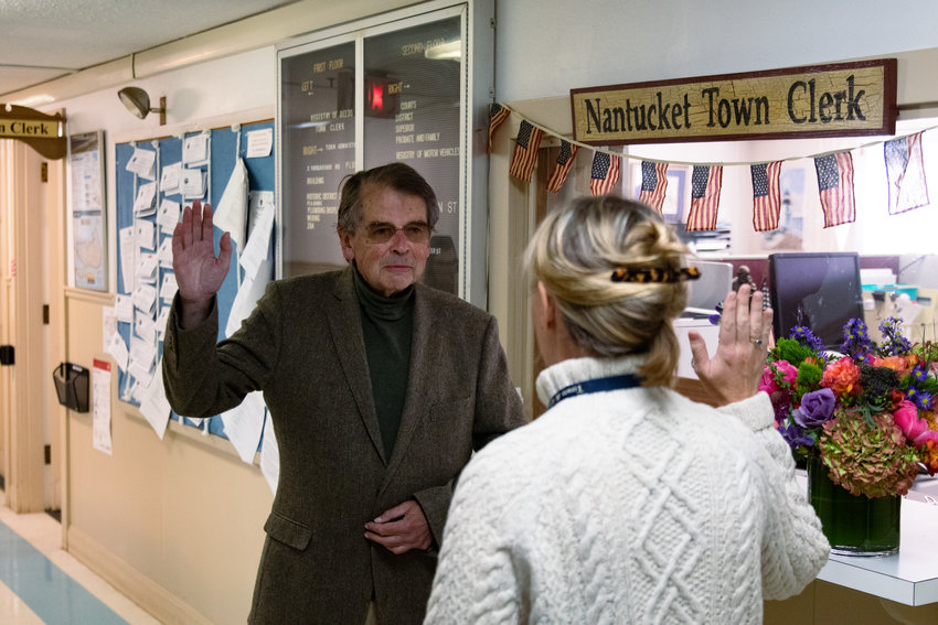 Malcolm MacNab is sworn in Wednesday morning by assistant town clerk Laura Raimo. MacNab won the special election for Select Board, narrowly beating Dave Iverson by 48 votes.