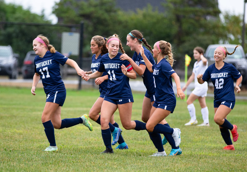 The girls soccer team celebrates a goal this season in one of its most successful campaigns in years.