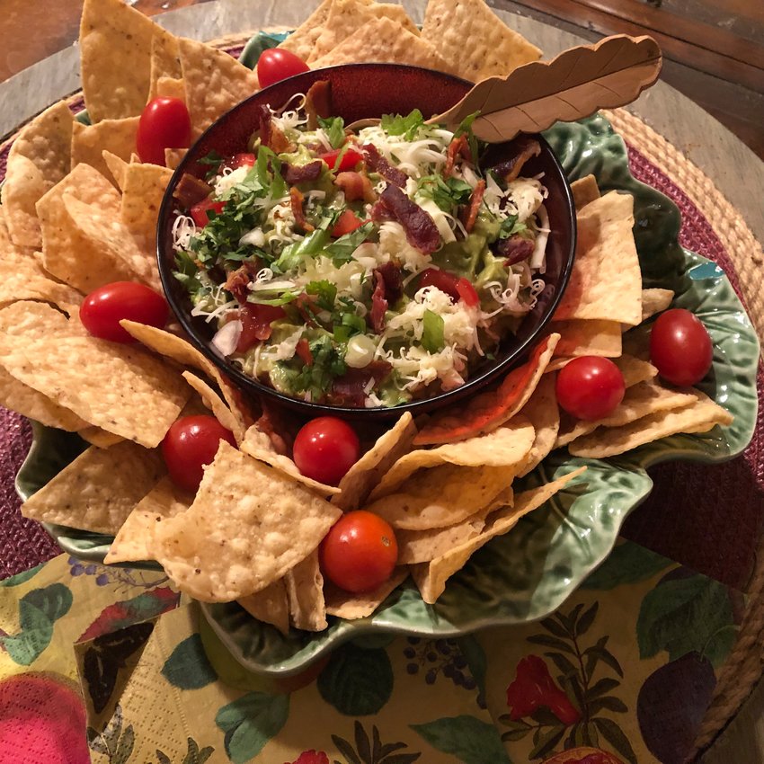Winter Guacamole is kicked up a notch through the addition of crisp, crumbled bacon, cheddar cheese and plum tomatoes.