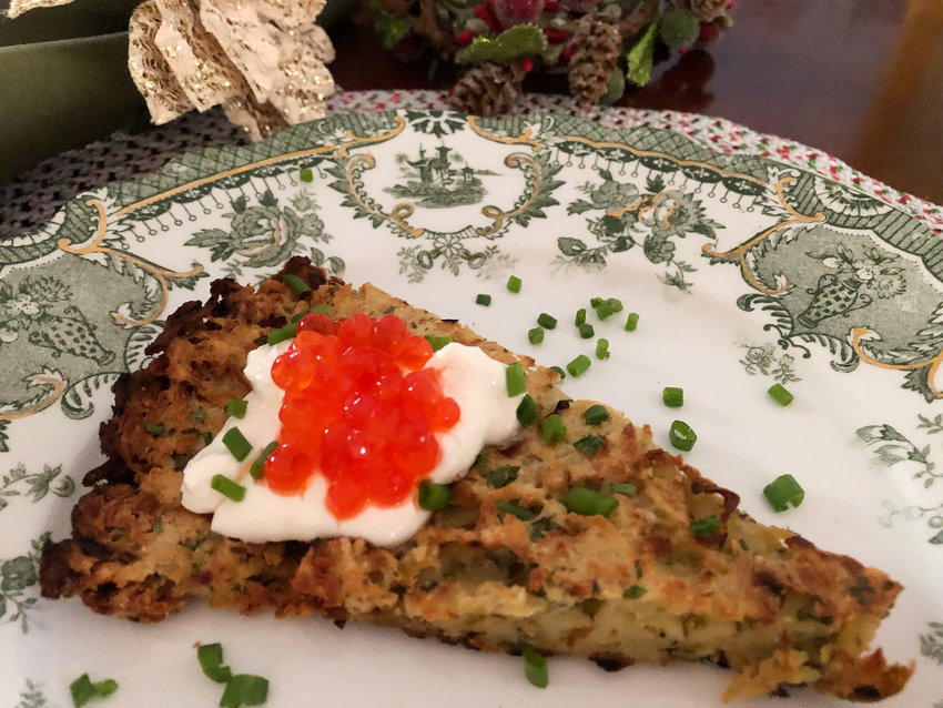 This easy-to-make skillet latke is topped by decadent dollops of cr&egrave;me fra&icirc;che and salmon caviar and a sprinkling of chives.
