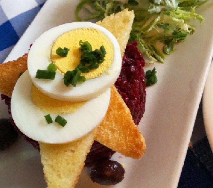 Le Languedoc&rsquo;s iconic Beet Tartare is served with hard-boiled egg, toast points and fresh field greens.