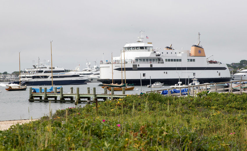 The Steamship Authority&rsquo;s car ferry Woods Hole leaving its berth while the fast ferry Iyanough arrives in Nantucket Harbor.