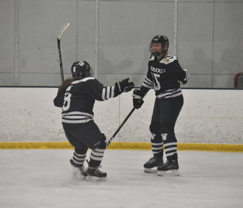 Mia Beaudette, right, and Lydia Johnson celebrate of Beaudette's second period goal in Sunday's game against Bishop Feehan.
