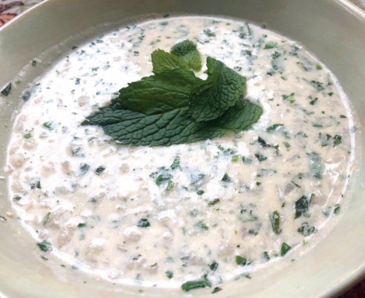 Tanabour is a silky yogurt soup filled with barley and fragrant fresh herbs.