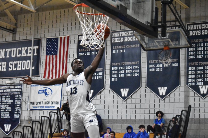 Jayquan Francis flies through the air for a slam dunk last Wednesday against Mashpee.