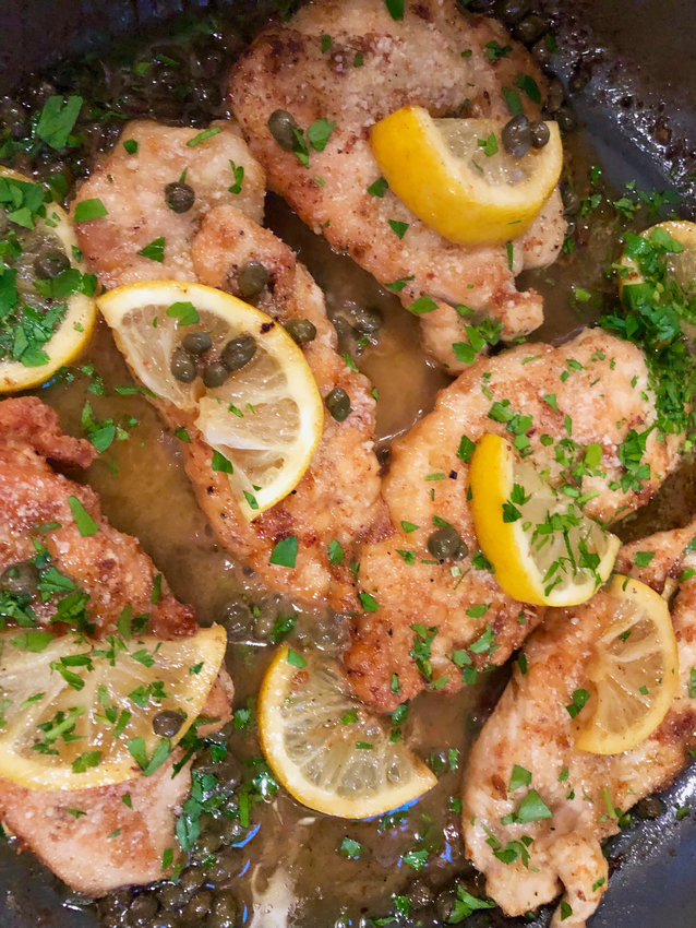 Parmesan cheese adds crispiness and flavor to the cooked chicken paired with a buttery, caper-speckled sauce in this Chicken Piccata.