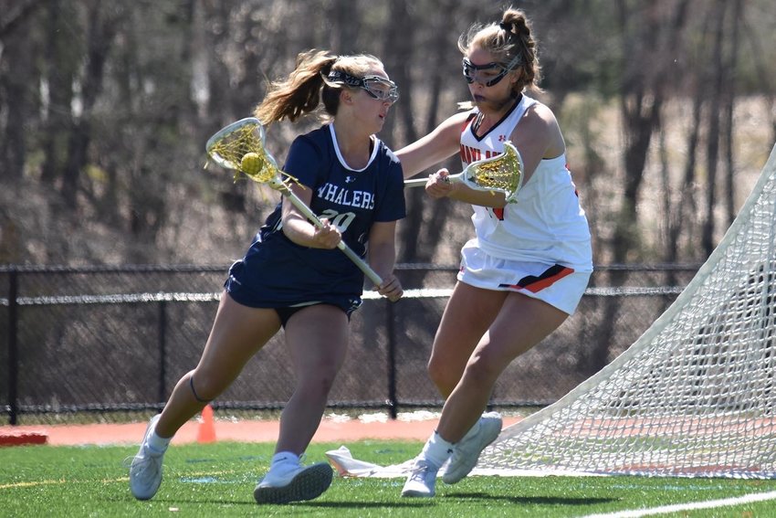 Cydney Mosscrop works around a Wayland defender during Saturday's game. Mosscrop led the Whalers with five goals in the 17-13 loss.