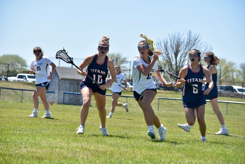 Suz Peraner splits two Pembroke defenders during Saturday&rsquo;s 16-1 win for the Whalers.