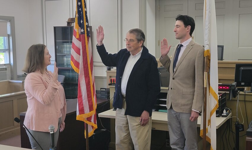 Newly-elected Select Board members Malcolm MacNab, left, and Tom Dixon are sworn in by town clerk Nancy Holmes Wednesday.