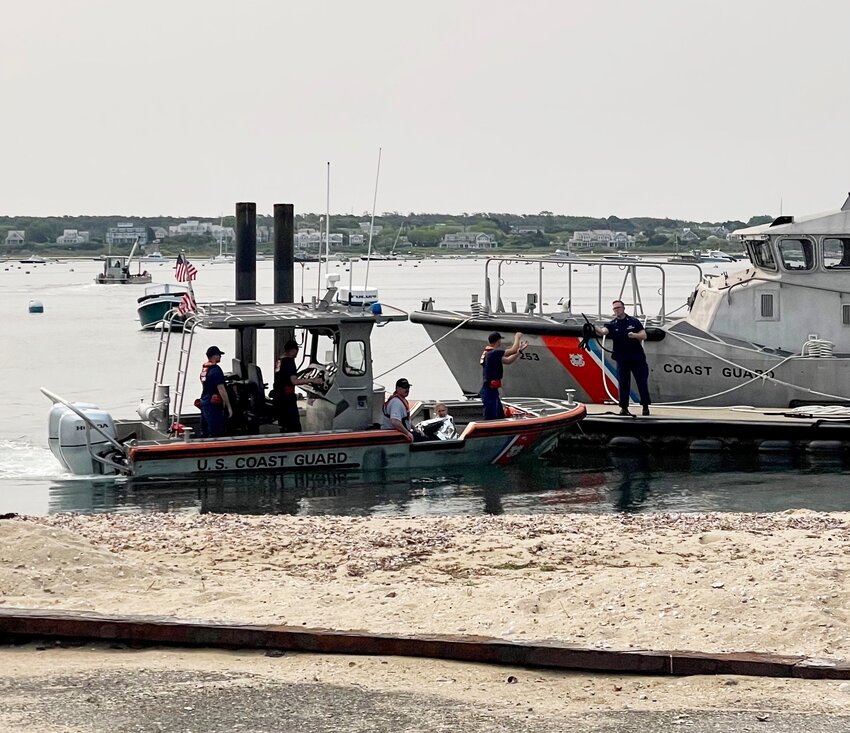 A Coast Guard Station Brant Point patrol boat returns a woman and her dog to the dock after pulling them from Nantucket Harbor near Cliffside Beach Club Thursday morning.
