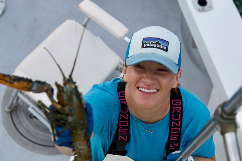 Ellie Mercer with a lobster aboard the Monomoy last week.