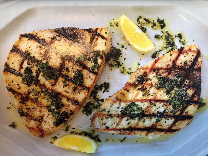 Swordfish Oreganata is topped with a vibrant blend of fruity olive oil, pungent chopped garlic, lemon and fresh oregano.