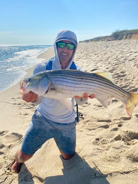 Pat McEvoy with a striped bass he caught on the south shore.