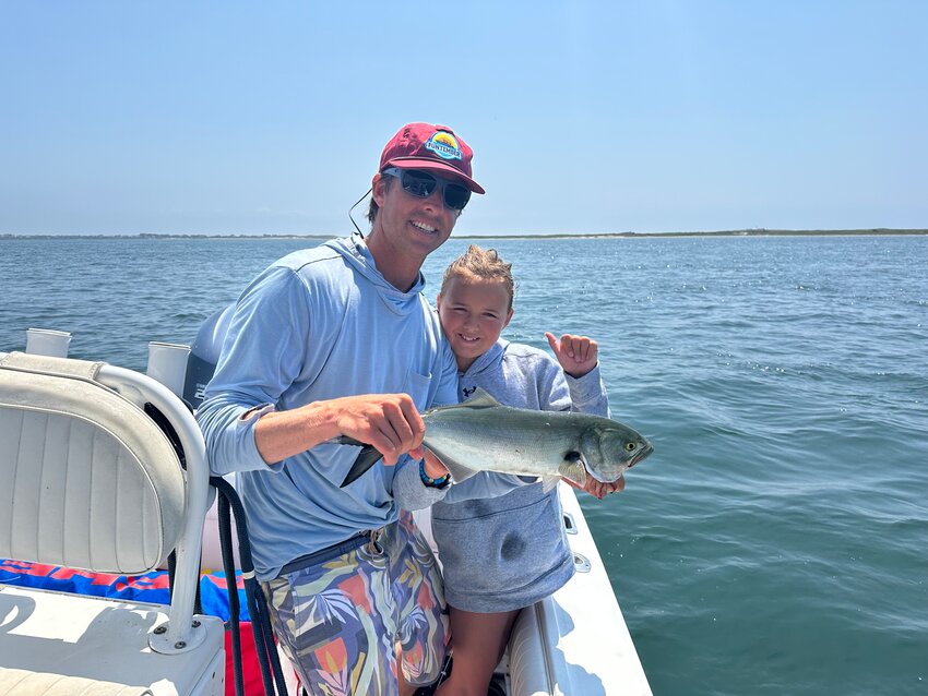 Cam and Morgan Gammill with a bluefish caught off the north shore this week.