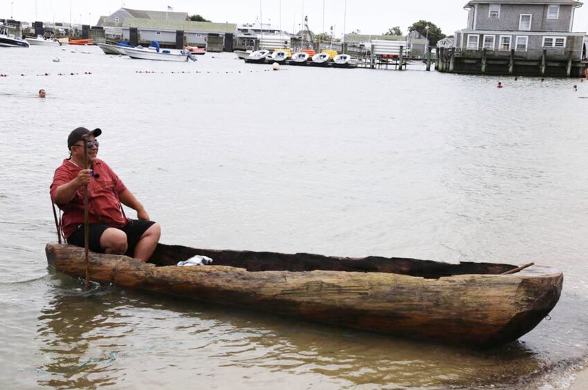 Mashpee Wampanoag Darius Coombs in a traditional mishoon, a dugout canoe, on Nantucket last August.