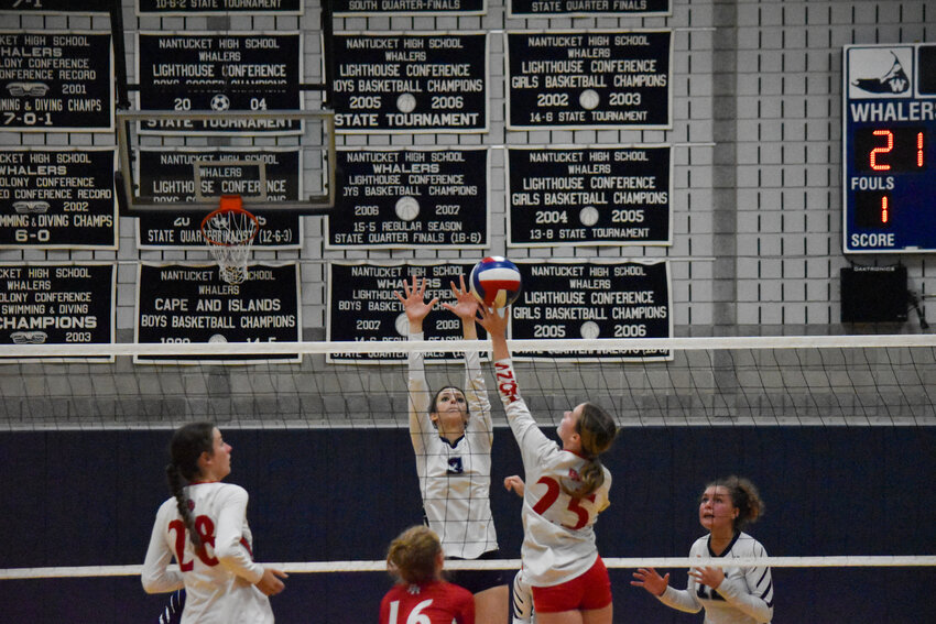 Leah Crowley (3) jumps up to block a spike from a Bridgewater-Raynham player during the Whalers&rsquo; 3-0 win over the Trojans at home Monday.