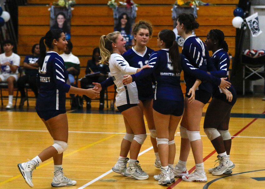 The Whalers celebrate after winning a point Friday against St. John Paul II.