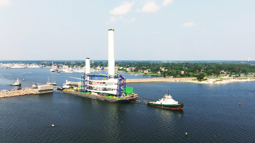 A Vineyard Wind turbine is barged out of New Bedford Harbor in mid-September.