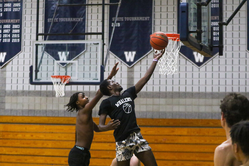 Jayquan Francis, right, drives to the hoop against Ethan Jarrett during boys basketball practice Monday.