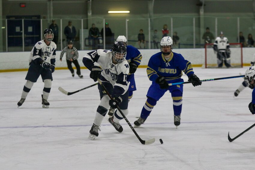Jeremy Jenkinson (13) carries the puck into the zone Sunday against Norwell.