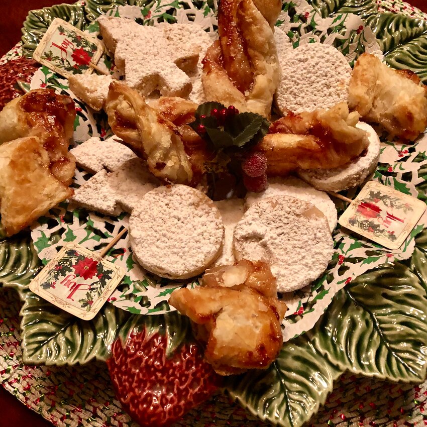 A selection of homemade Christmas cookies including Cold Moon Cookies and Puff Pastry Bow Ties made with strawberry jam provide a delightfully retro spin to the holiday table.