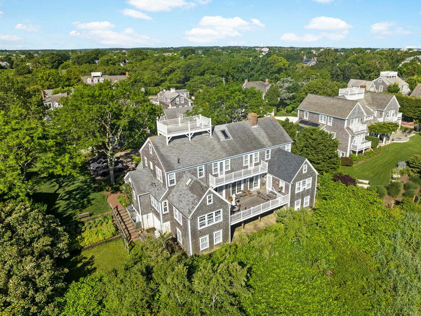 This 10-bedroom, 10-and-a-half-bathroom compound is perched high on Cliff Road with spectacular views of Nantucket Harbor and Nantucket Sound.