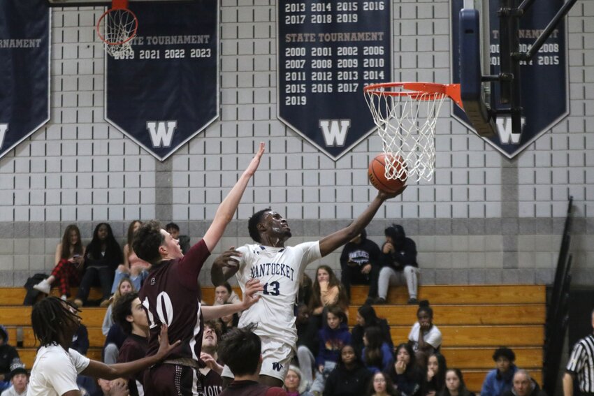 Jayquan Francis (13) leaps for a lay up during the Whalers' 63-41 win Saturday against Falmouth.