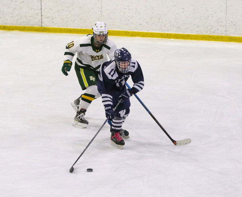 Emerson Pekarcik (11) skates past a King Philip defender during the Whalers 12-2 loss Monday.