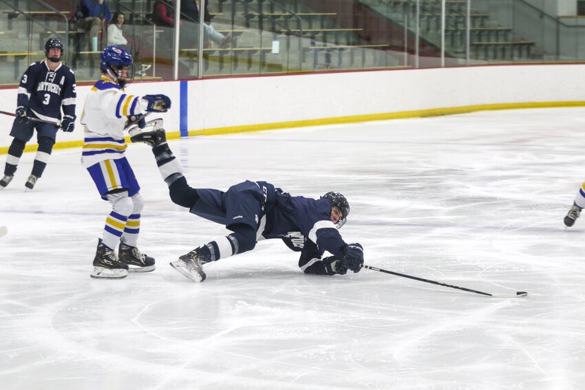 Braden Knapp makes a play on the puck while sprawled out on the ice in Monday&rsquo;s 6-1 win against St. John Paul II.