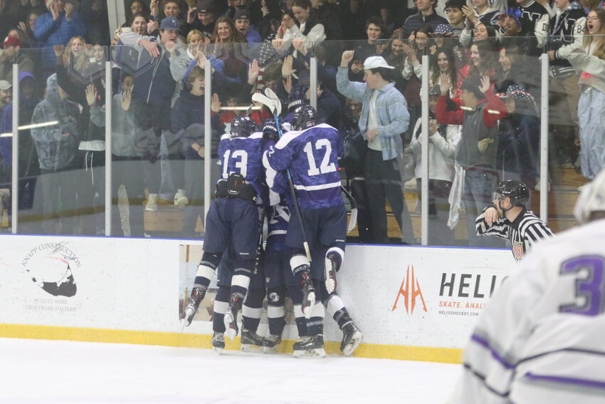 The Whalers celebrate in front of the student section after a goal during Saturday's 5-3 win over Martha's Vineyard.