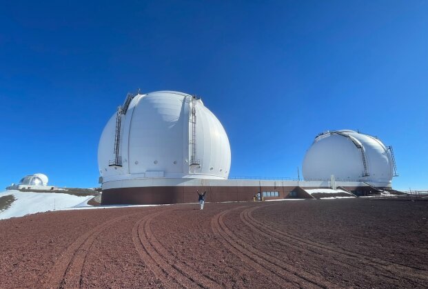 Maria Mitchell Association research fellow Emmy Wisz in front of the Keck I (right) and Keck II telescopes on top of Mauna Kea in Hawaii.