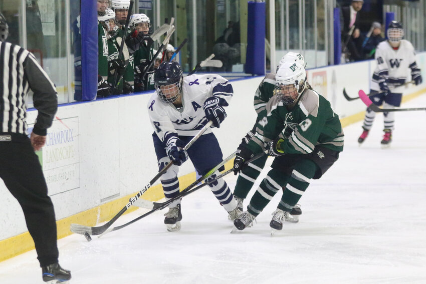 Bailey Lower, left, carries the puck past a D-Y player during last Wednesday&rsquo;s 8-5 loss.