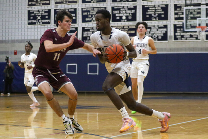 Jayquan Francis, right, drives to the basket Saturday in Nantucket&rsquo;s 64-61 playoff win over Carver