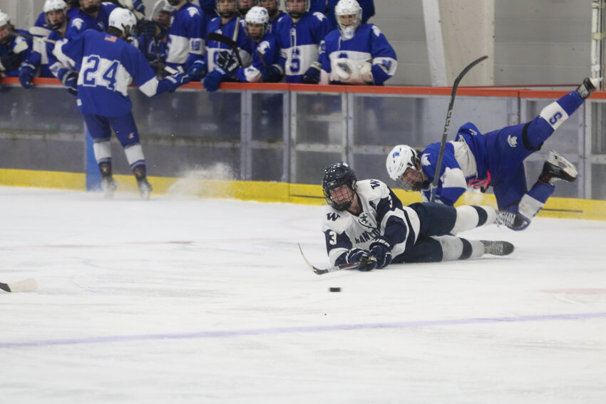 Mike Culkins (3) makes a pass while sprawled on the ice last Wednesday against Stoneham in the Div. 4 state tournament round of eight.