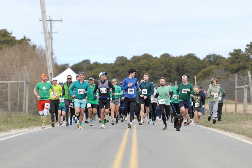 Runners and walkers take off from the start line at Cisco Brewers on Bartlett Road.