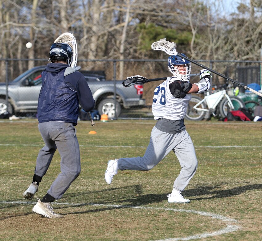 Nolen Mosscrop, right, sends a behind-the-back shot past goalie Jeremy Jenkinson during the first day of spring sports practices Monday.