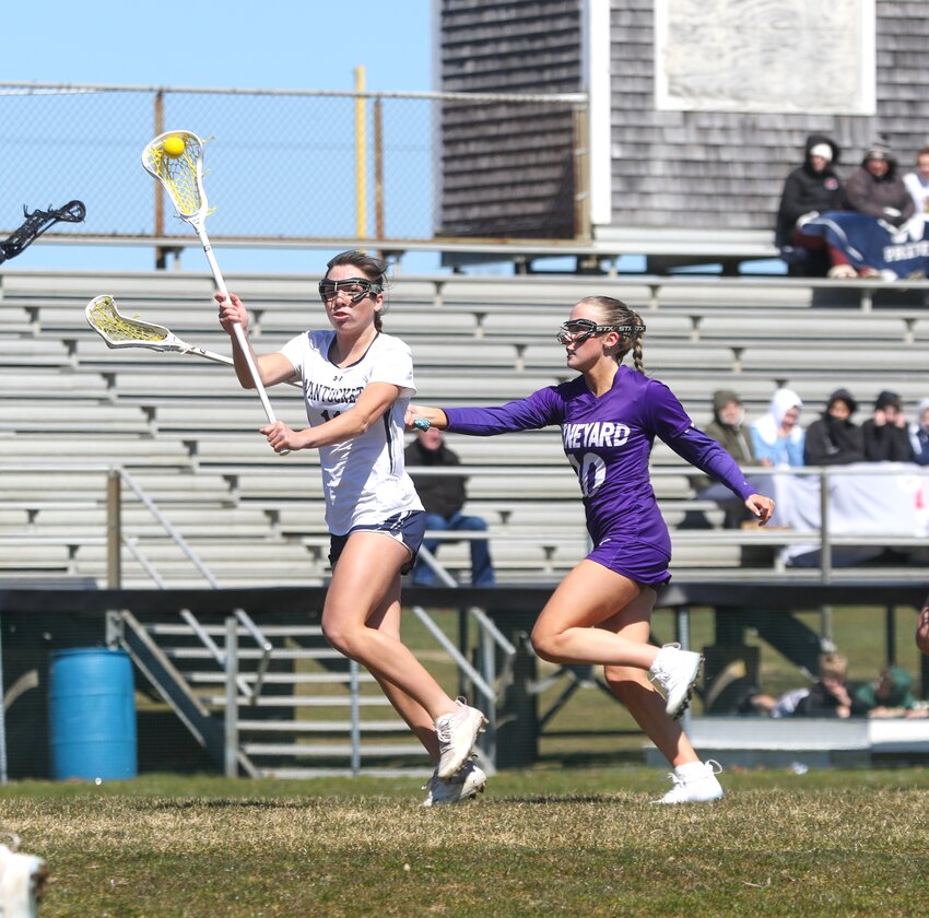 Emerson Pekarcik, left, passes to a teammate during the Whalers&rsquo; 16-1 win over Martha&rsquo;s Vineyard Saturday. The senior had three goals and an assist in the victory.