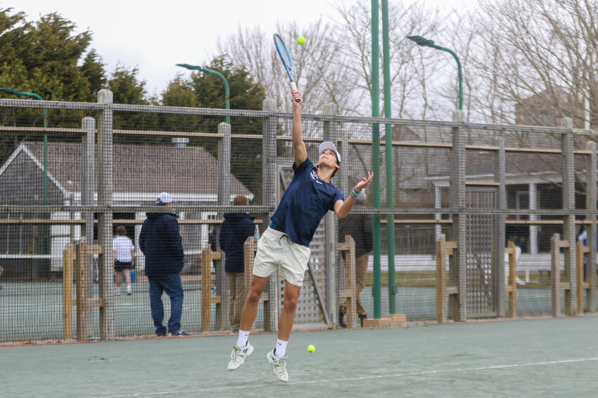 Henry Kathawala delivers a serve Saturday against Plymouth South.