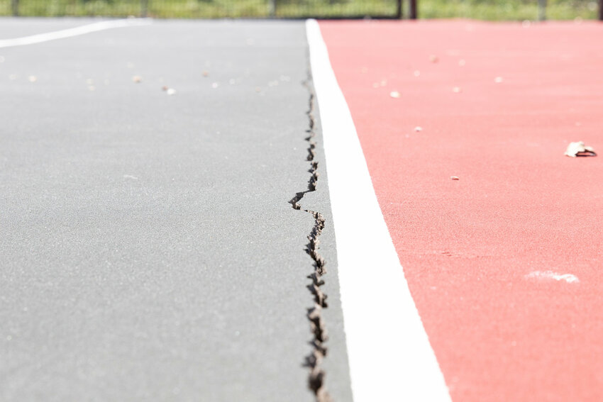 The cracked tennis courts at Jetties Beach.