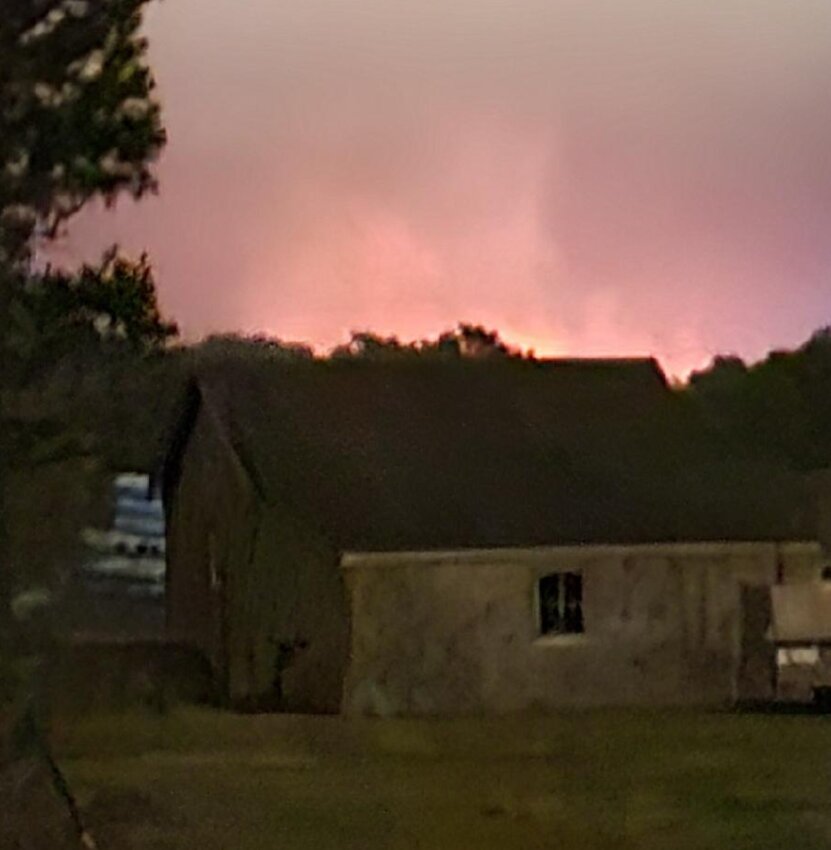 A glow in the sky from a large brush fire burning between Old South and Milestone roads Tuesday night.