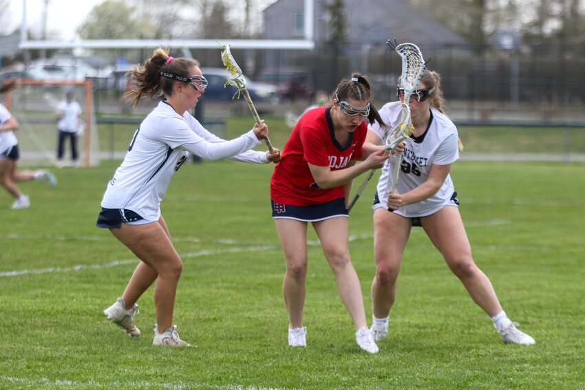 Cydney Mosscrop, left, and Mayson Lower surround a Bridgewater-Raynham player in the Whalers&rsquo; 14-6 win Tuesday.