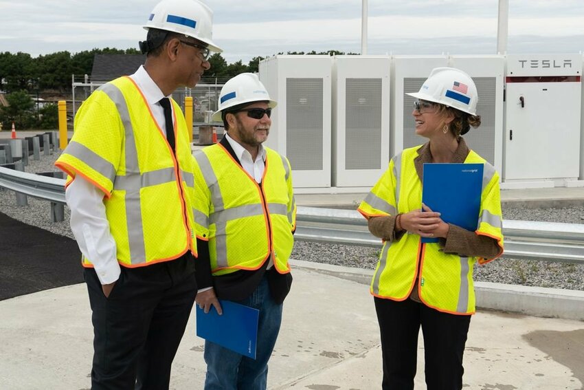 Rudy Wynter of National Grid chats with Tristan Glenwright of Tesla, and Lauren Sinatra, Nantucket's energy coordinator, during a tour of National Grid's new Bunker Road back-up power system in 2019. The Tesla batteries are intended to provide energy islandwide in the event one of two undersea cables goes down.