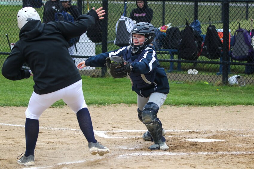 Catcher Aliza Mansfield tags out a Rising Tide runner at the plate during the Whalers' 17-10 win Friday.