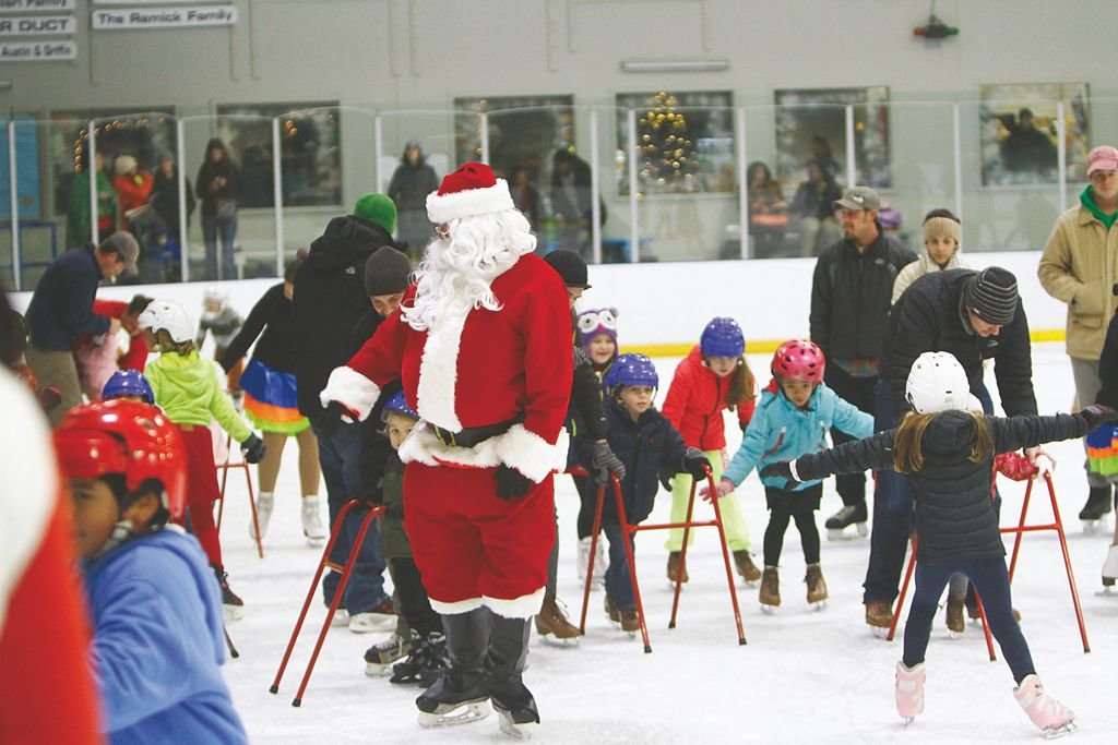 Children skate with Santa Claus at the Nantucket Ice rink on Backus Lane during Christmas vacation.