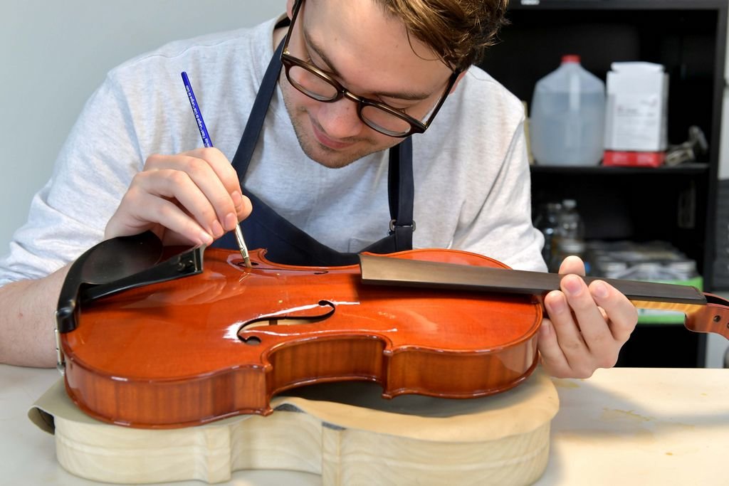 Nathan Abbe works on a violin at Boston's North Bennet Street School. Abbe will speak next week as part of Nantucket's One Book One Island program centered around Richard Powers' &#8220;The Overstory.&#8221;